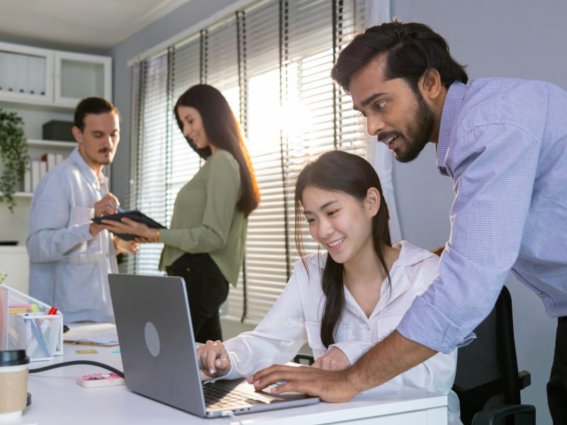 Group of multiethnic young business friends gathered in a modern office conference room and worked as a team.